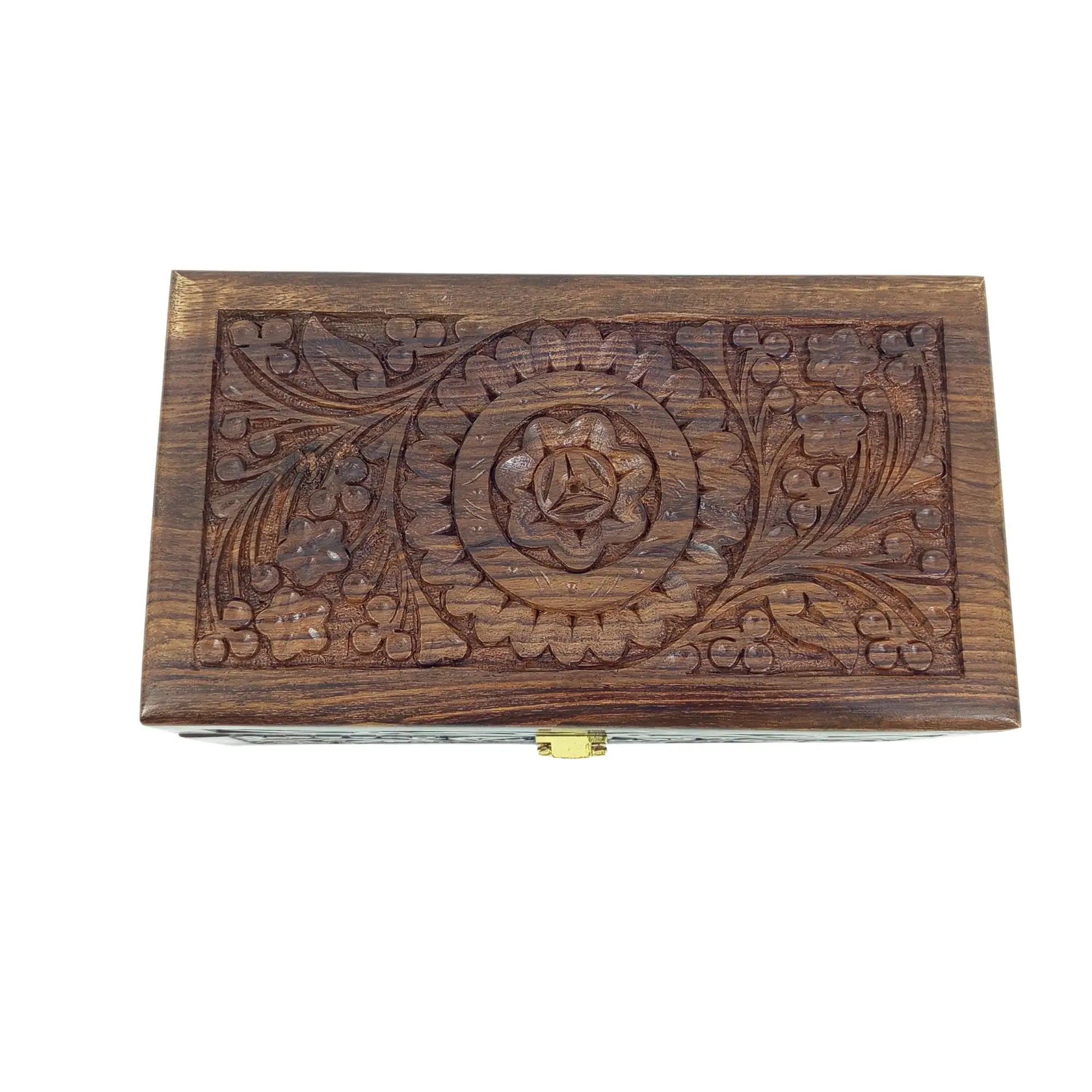 Wooden box with floral carvings on a white background