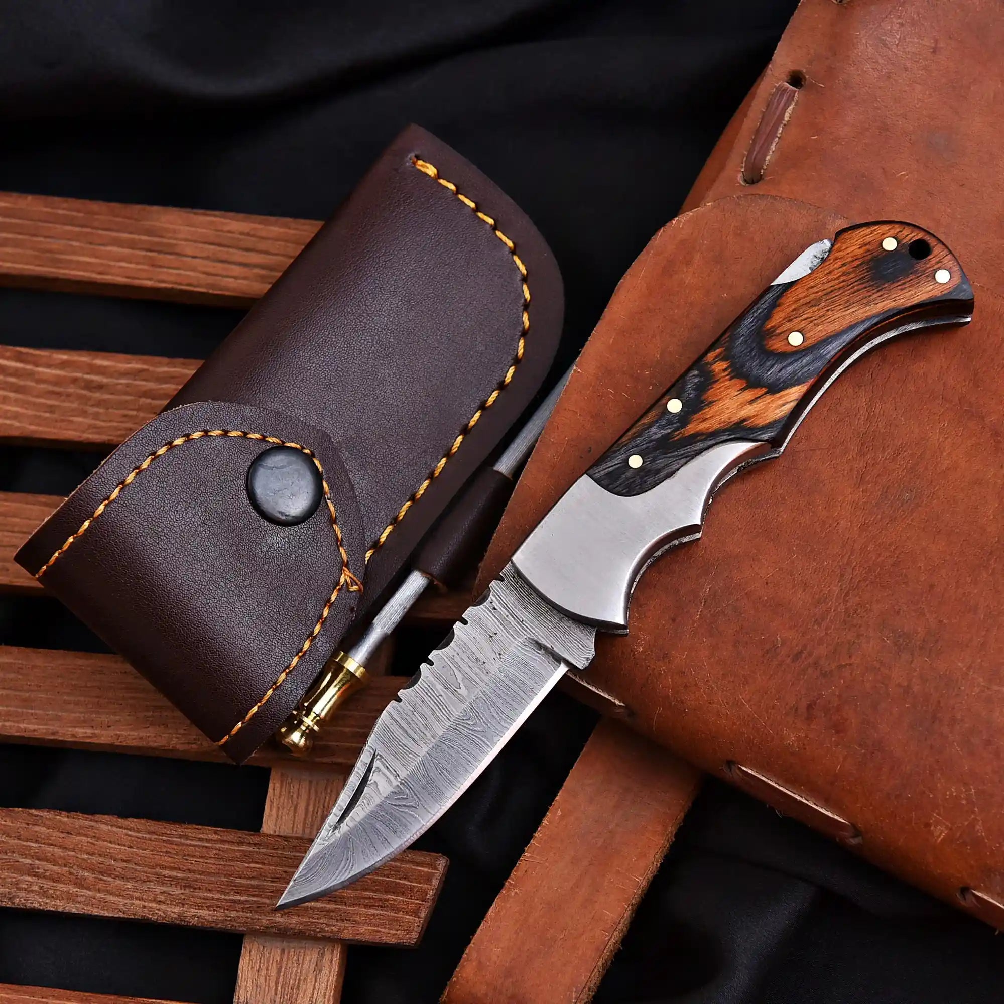 Hand forged Damascus folding knife close-up