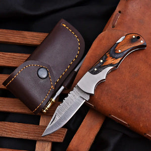 Hand forged Damascus folding knife close-up