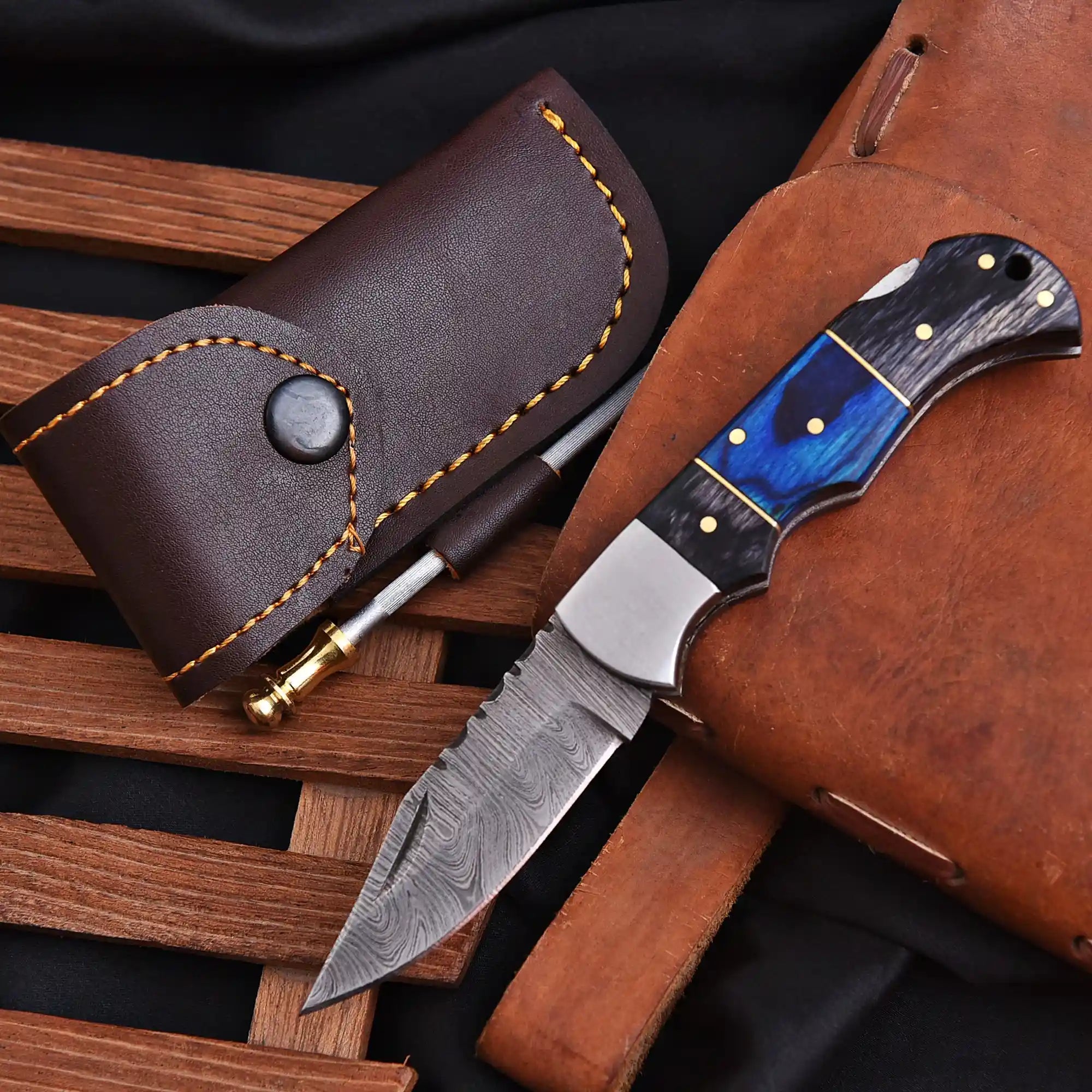 Knife with a blue blade and wooden handle in a brown leather sheath